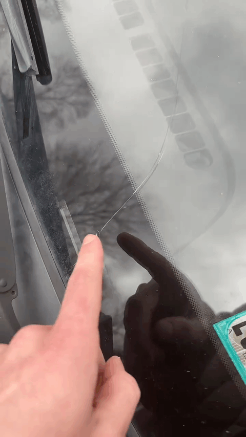 A crack running up from the edge of a windshield